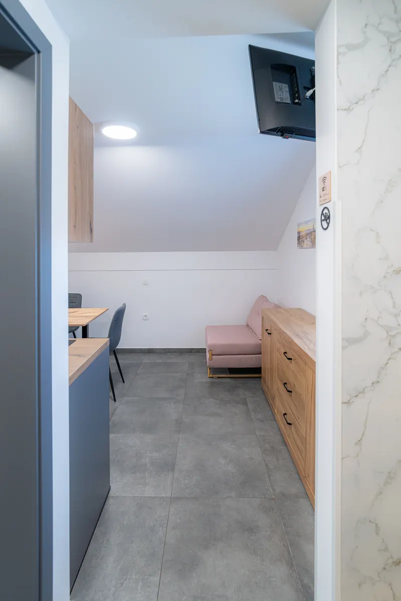 Bivalni prostor apartmaja 7 s kuhinjo, jedilno mizo in kavčem